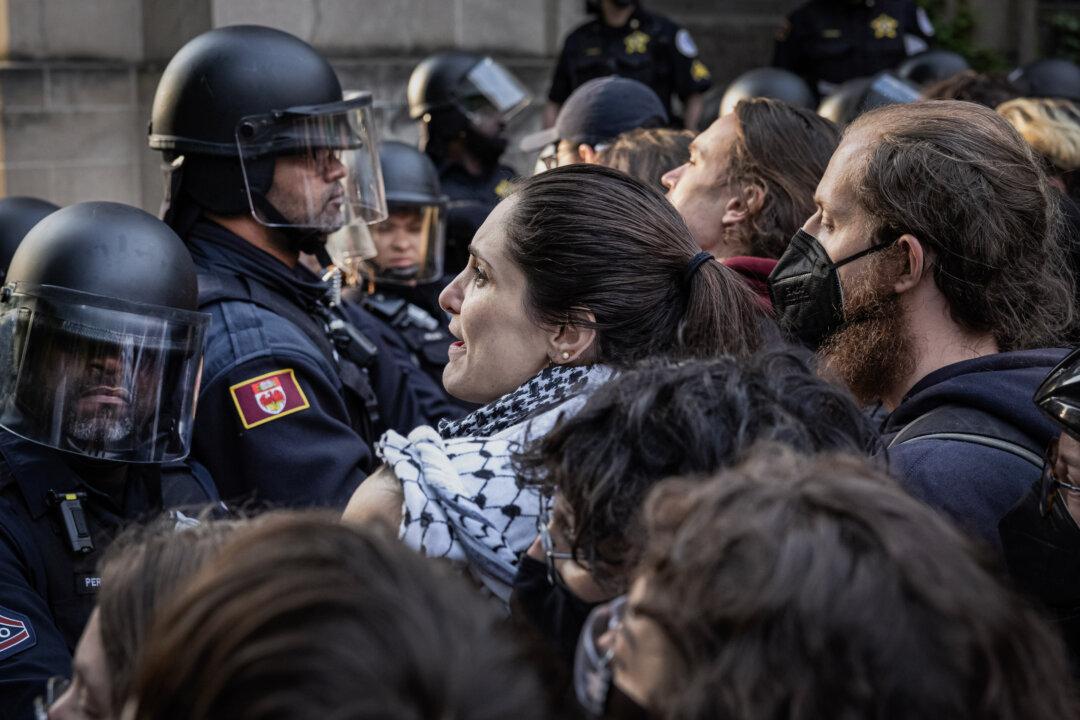 University police are confronted by protesters at the University of Chicago campus as they move to break up a pro-Palestinian encampment in Chicago on May 7, 2024. (Scott Olson/Getty Images)