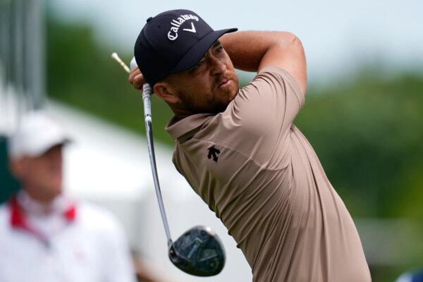 Xander Schauffele eyes his tee shot on the 10th hole during the first round of the Wells Fargo Championship golf tournament in Charlotte, N.C., on May 9, 2024, (Erik Verduzco/AP Photo)