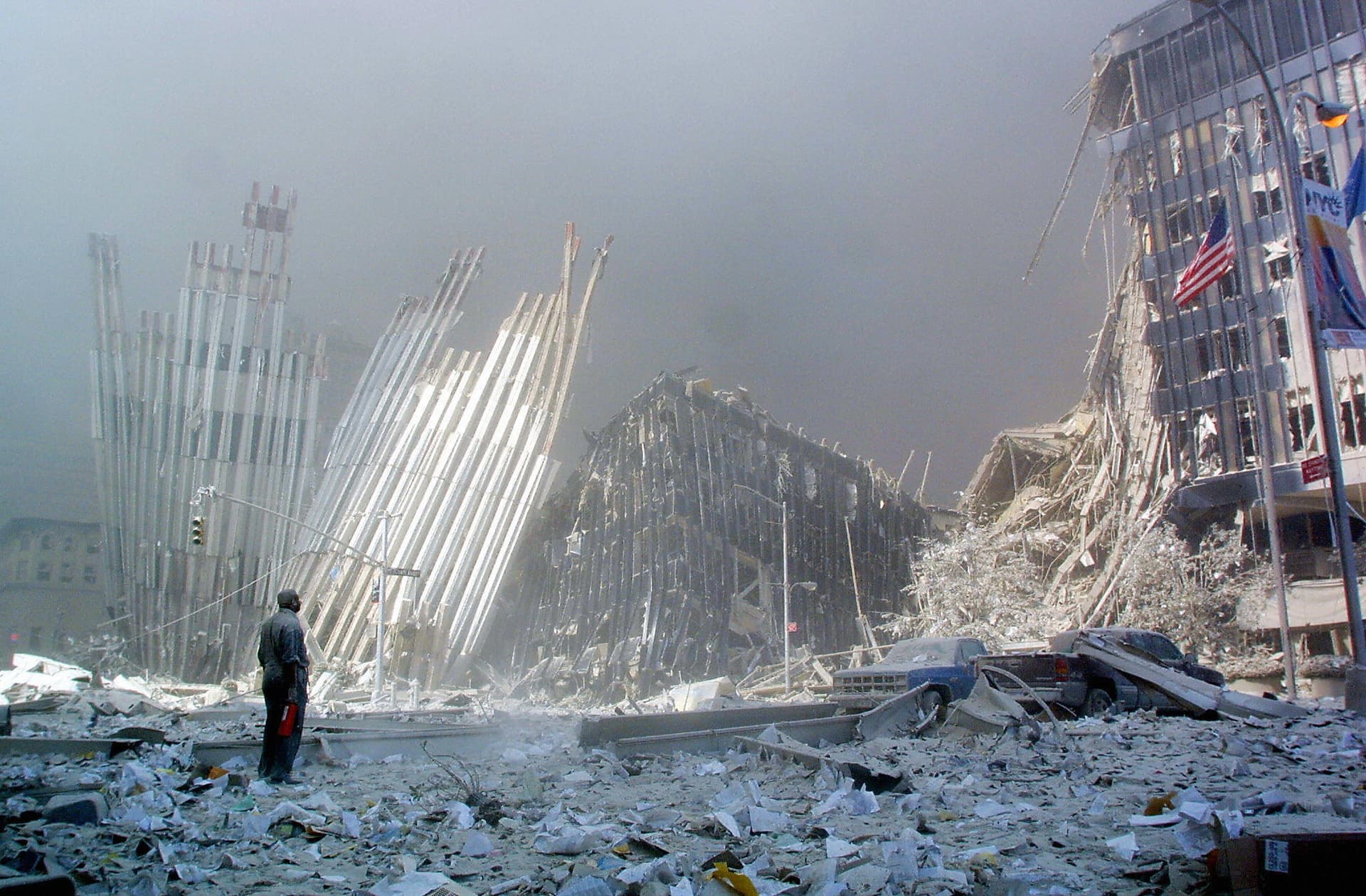 A man standing amid rubble calls out asking if anyone needs help following the collapse of the first World Trade Center tower in New York on Sept. 11 2001. (Doug Kanter/AFP/Getty Images)