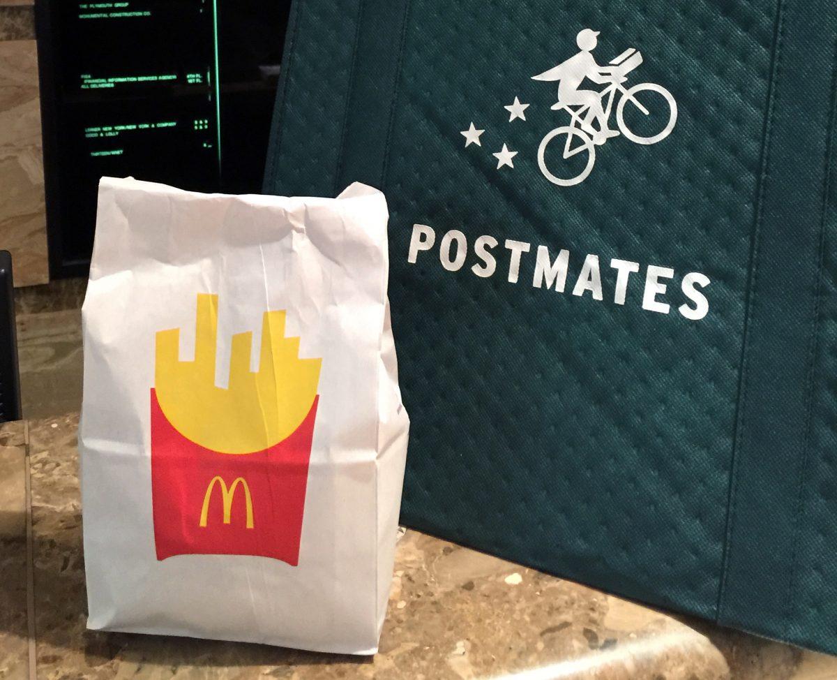 A bag of food from McDonald's ordered through the Postmates service sits next to a Postmates delivery bag during a delivery in New York on May 6, 2015. (Candice Choi/AP Photo)