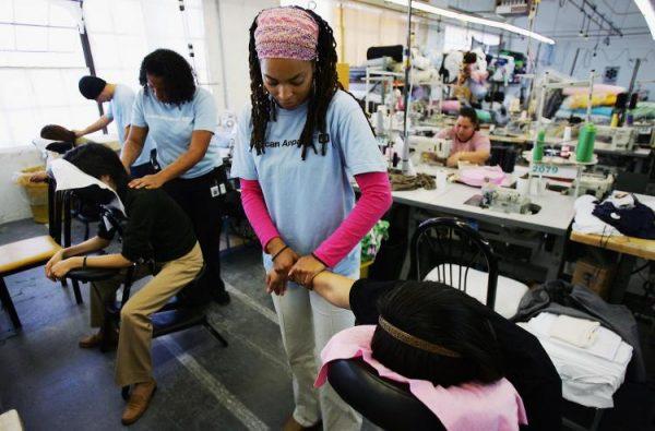 Workers at American Apparel in Los Angeles take a massage break. (David McNew/Getty Images)