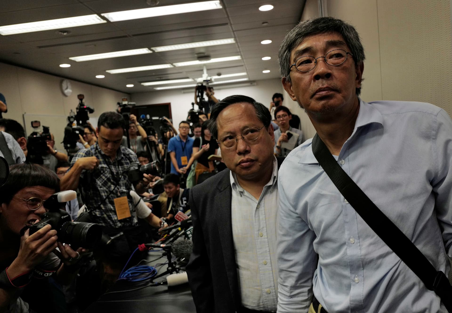 Freed Hong Kong bookseller Lam Wing-kee (R) is accompanied by pro-democracy lawyer Albert Ho after giving a news conference in Hong Kong on June 16, 2016. (AP Photo/Vincent Yu)