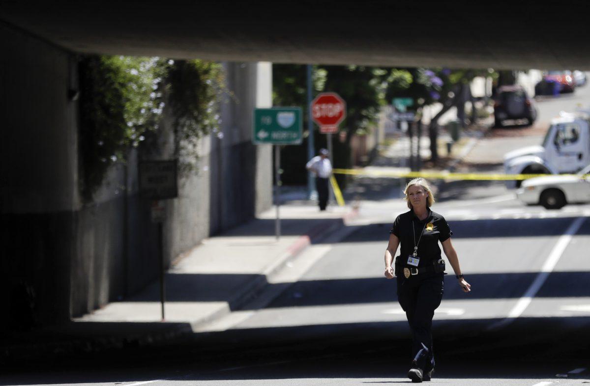 A police official walks near a crime scene in San Diego on July 15, 2016. (Gregory Bull/AP Photo)