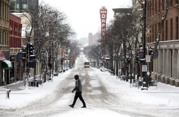 A man crosses the street in Madison, Wis., on Dec. 11, 2016. (Steve Apps/Wisconsin State Journal via AP)