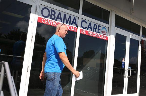 A man walks out of a UniVista Insurance office after shopping for a health plan under the Affordable Care Act in Miami on Dec. 15, 2015. (Joe Raedle/Getty Images)