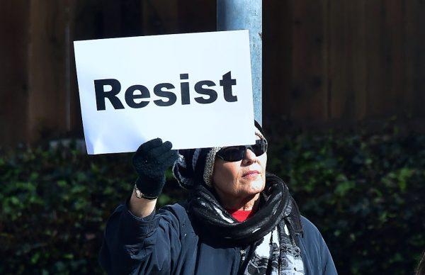 A demonstrator along El Camino Real in San Mateo, Calif., on Jan. 20, 2017, Donald Trump's first Inauguration Day. (Frederic J. Brown/AFP/Getty Images)