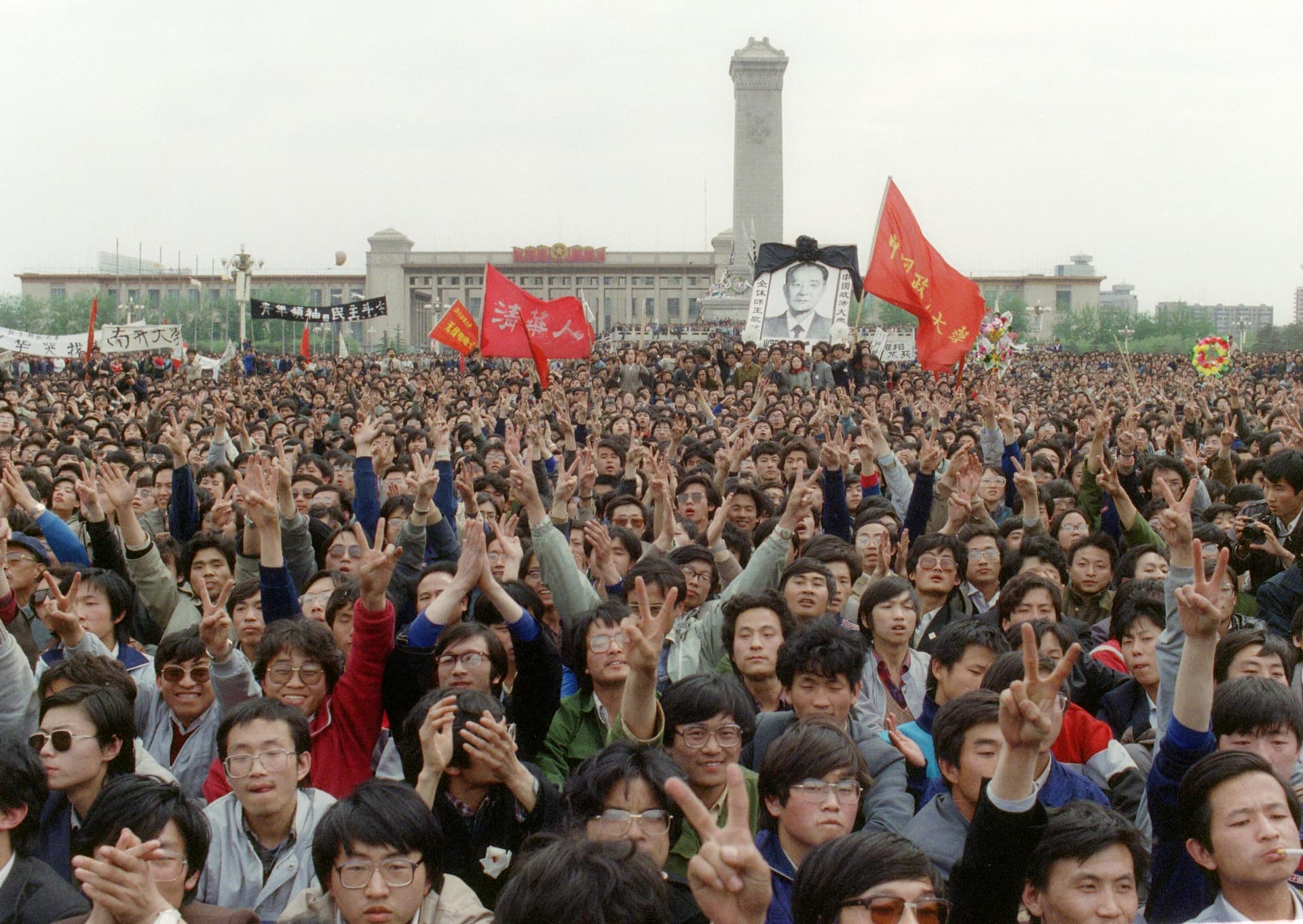 Students gesture and shout slogans as they pay respect to former Chinese Communist Party leader and liberal reformer Hu Yaobang as thousands of students gather near the Monument to the People's Heroes in Tiananmen Square during an unauthorized demonstration to mourn the death of Hu in Beijing on April 22, 1989. (Catherine Henriette/AFP/Getty Images)