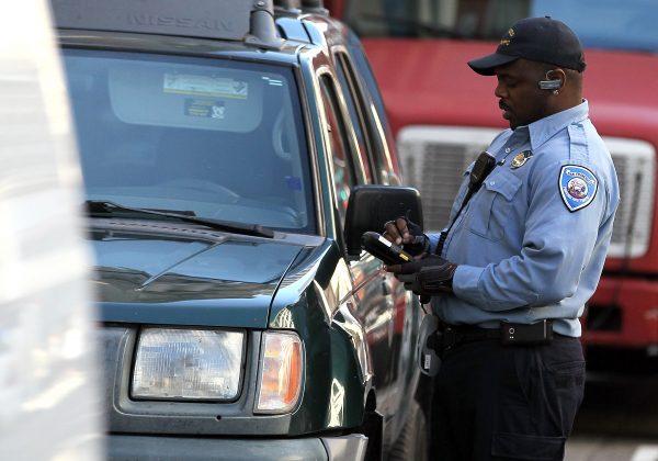 A San Francisco Department of Parking and Traffic issues a parking ticket for an illegaly parked car in San Francisco, Calif., on Jan. 21, 2011. (Justin Sullivan/Getty Images)