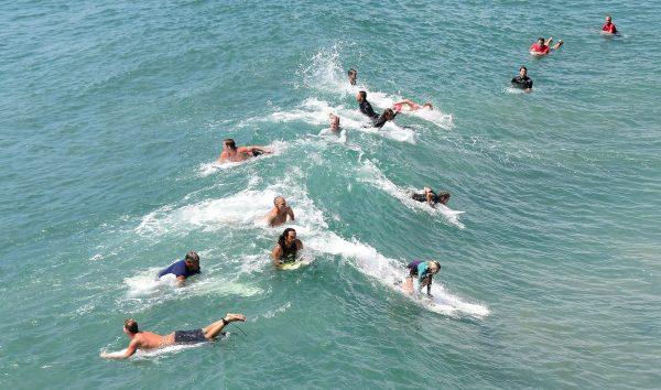 Surfers catch a wave at Huntington Beach, Calif. on Sept. 10, 2015. (Frederic J. Brown/AFP/Getty Images)