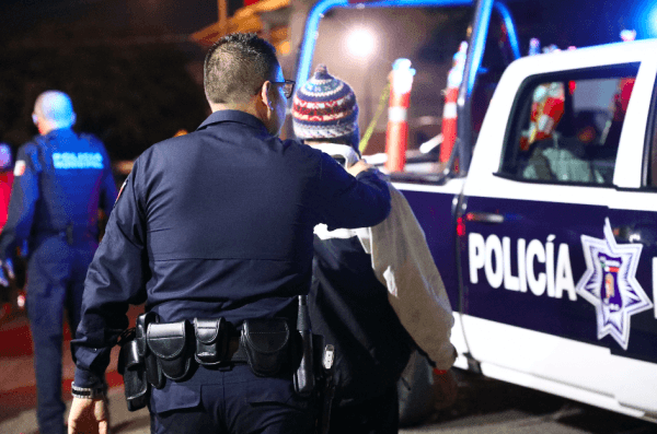 Tijuana municipal police arrest two members of a migrant caravan for alleged marijuana possession at a municipal sports complex in Tijuana, Mexico, on Nov. 17, 2018. (Charlotte Cuthbertson/The Epoch Times)