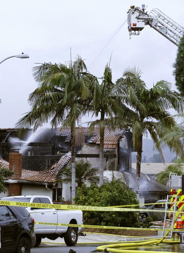 Firefighters work the scene of a deadly plane crash in the residential neighborhood of Yorba Linda, Calif., on Feb. 3, 2019. The Federal Aviation Administration said a twin-engine Cessna 414A crashed in Yorba Linda shortly after taking off from the Fullerton Municipal Airport. (Alex Gallardo/AP Photo)