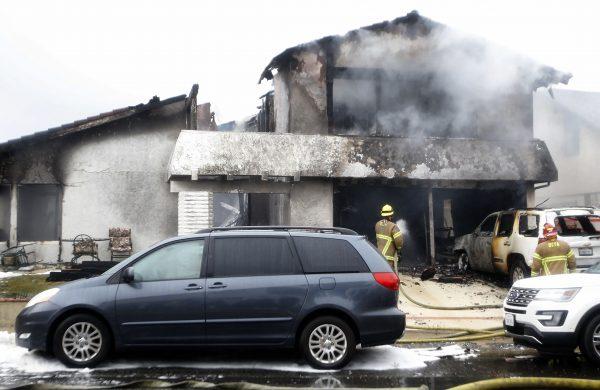 Firefighters work the scene of a deadly plane crash in the residential neighborhood of Yorba Linda, Calif., on Feb. 3, 2019. The FAA said a twin-engine Cessna 414A crashed in Yorba Linda shortly after taking off from the Fullerton Municipal Airport. (Alex Gallardo/AP Photo)