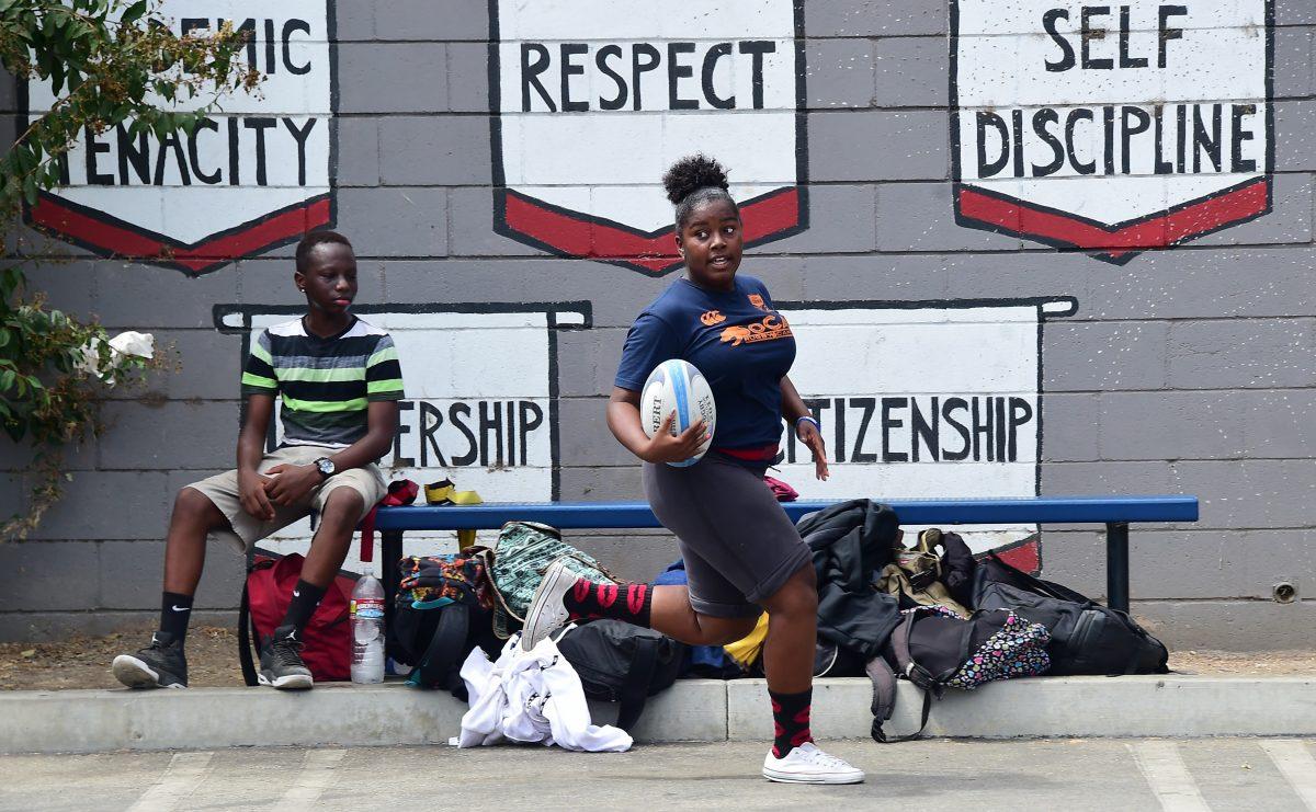 Students from View Park Preparatory Accelerated Charter High School play a game of rugby on the parking lot field on campus in Los Angeles, California, on September 11, 2015. (Frederic J. Brown/AFP/Getty Images)