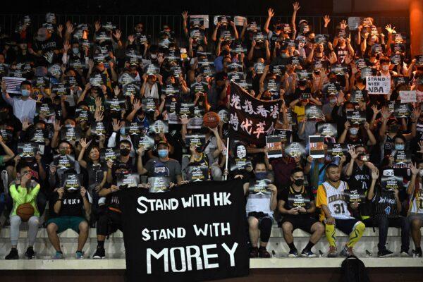 Protesters shout slogans as they hold flyers at the Southorn Playground in Hong Kong on Oct. 15, 2019, during a rally in support of NBA basketball Rockets general manager Daryl Morey and against comments made by Lakers superstar LeBron James. (Anthony Wallace/AFP via Getty Images)