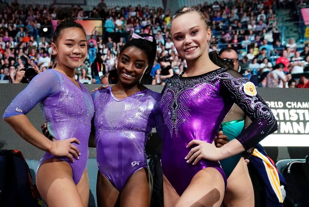 (L–R) USA's Sunisa Lee (2nd) and Simone Biles (1st) and Russia's Angelina Melnikova (3rd) pose after the floor event of the apparatus finals at the FIG Artistic Gymnastics World Championships at the Hanns-Martin-Schleyer-Halle in Stuttgart, southern Germany, on Oct. 13, 2019. (Lionel Bonaventure/AFP via Getty Images)