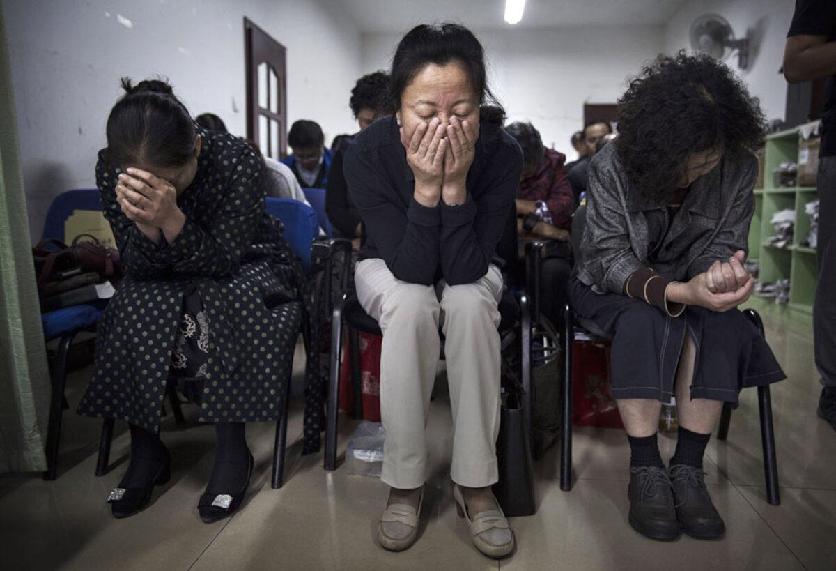 Chinese Christians pray during a service at an underground independent Protestant Church in Beijing. China, an officially atheist country, places a number of restrictions on Christians and allows legal practice of the faith only at state-approved churches. (Kevin Frayer/Getty Images)