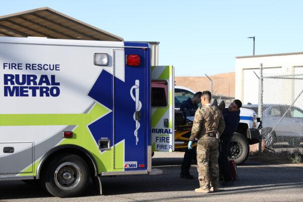Border Patrol BORSTAR agents assist in loading a man with a suspected broken back into a waiting emergency vehicle in the Imperial Sand Dunes, Calif., on Nov. 29, 2019. (Charlotte Cuthbertson/The Epoch Times)