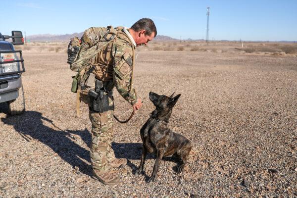 Border Patrol BORSTAR supervisory agent Chad Smith and his K-9 Kyra prepare for a training exercise near the Imperial Sand Dunes, Calif., on Nov. 30, 2019. (Charlotte Cuthbertson/The Epoch Times)