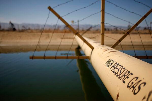 A high-pressure gas line crosses over a canal in an oil field over the Monterey Shale formation where hydraulic fracturing, or fracking, is used to extract gas and oil near McKittrick, Calif., on March 23, 2014. (David McNew/Getty Images)