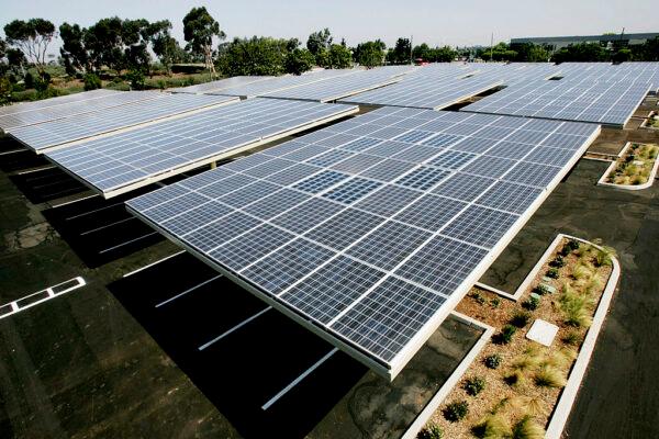 Solar panels sit above the Solar Grove parking lot at the Kyocera Plant in San Diego, Calif., on June 24, 2005. The Solar Grove is an array of 25 solar panels that turns a 186 vehicle parking lot into a 235 Kilowatt solar electric generating system. (Sandy Huffaker/Getty Images)