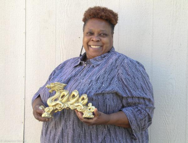 Phyllis "Dragon Slayer" McNeal holds a dragon statue on Feb. 1, 2020. (Makenna Mullins for The Epoch Times)
