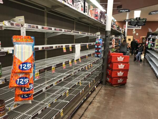 The toilet paper and paper towel aisle at Ralphs in Menifee, Calif., on March 15. 2020. (Brad Jones/The Epoch Times)