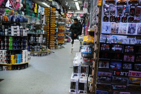 A worker sits in an empty gift shop in New York City’s Chinatown neighborhood on Feb. 13, 2020. The Department of Small Business Services in New York reported at the time that revenues were already down by 40 percent in Chinatown due to CCP virus concerns. (Spencer Platt/Getty Images)