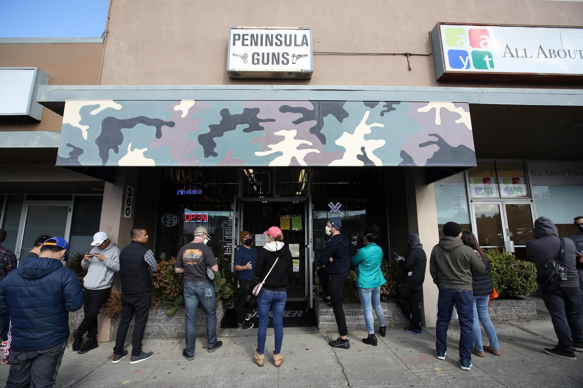 People wait in line outside a gun store in San Bruno, Calif., on March 16, 2020. (Justin Sullivan/Getty Images)