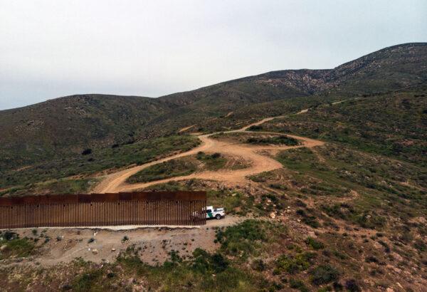 A Border Patrol vehicle is parked next to a section of the U.S.-Mexico border fence as it ends at El Nido de las Aguilas, eastern Tijuana, Baja California state, on March 26, 2019. (Guillermo Arias/AFP via Getty Images)