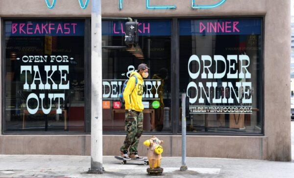 Chairs remain stacked on tables at a restaurant open for takeout in Los Angeles, California, on May 12, 2020. (Frederic J. Brown/AFP via Getty Images)