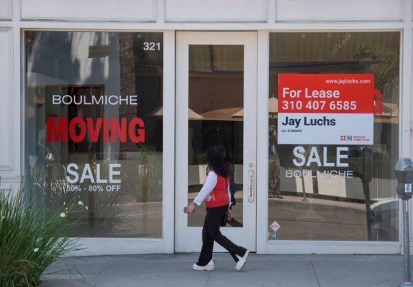 People walk past empty stores and restaurants in Beverly Hills, Calif., on May 8, 2020. (Mark Ralston/AFP via Getty Images)