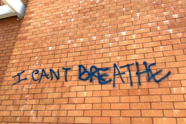 George Floyd's last words are seen spray-painted on a wall in Santa Ana, Calif., on June 1, 2020. (Chris Karr/The Epoch Times)