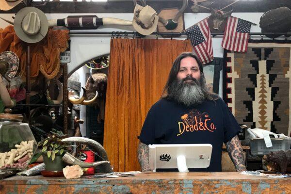 Matt De Vaul stands amid the assortment of curious collectibles in his MMD Antiques shop in Old Towne Orange, Calif., on May 30, 2020. (Chris Karr/The Epoch Times)