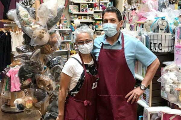 Jeanie and Gilbert Viveros stand inside their reopened store, Tiddlywinks Toys and Games, in Old Towne Orange, Calif., on May 30, 2020. (Chris Karr/The Epoch Times)