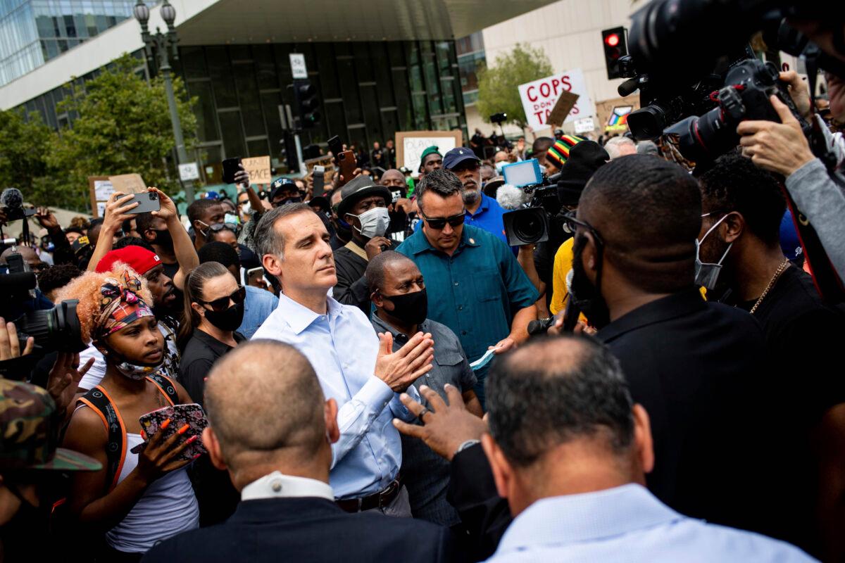 Los Angeles Mayor Eric Garcetti joins pastors and marchers outside LAPD Headquarters during a demonstration demanding justice for George Floyd in Los Angeles, Calif. on June 2, 2020. (Sarah Reingewirtz/The Orange County Register/AP)