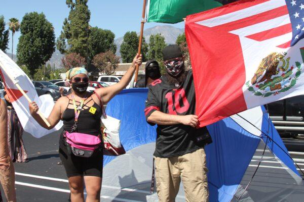 Abigail Gonzalez flies a flag at a staging area in Calimesa, Calif., preparing for a Black Lives Matter protest in nearby Yucaipa, Calif., on Aug. 1, 2020. (Brad Jones/The Epoch Times)