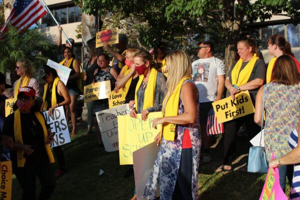 Parents at a protest calling for the reopening of Orange County schools listen to a speaker outside the Santa Ana Educators Association building in Santa Ana, Calif., on Aug. 4, 2020. (Jamie Joseph/The Epoch Times)