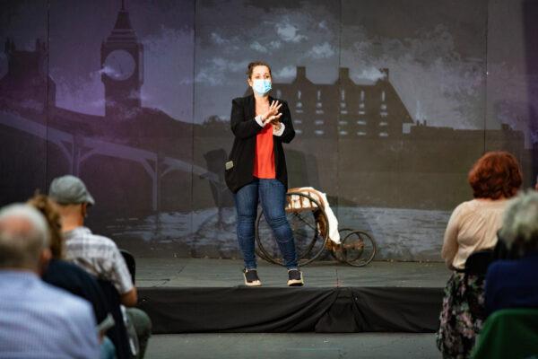 Chelsea Braverman, founder of the youth theater group Braver Players, speaks to the crowd before the group's outdoor performance of "Jekyll & Hyde" in Costa Mesa, Calif., on Aug. 5, 2020. (John Fredricks/The Epoch Times)