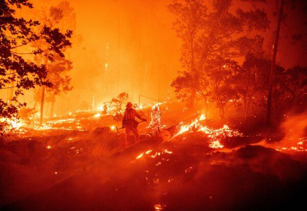 A firefighter works the scene as flames push towards homes during the Creek fire in the Cascadel Woods area of unincorporated Madera County, Calif., on Sept. 7, 2020. ( Josh Edelson/AFP via Getty Images)