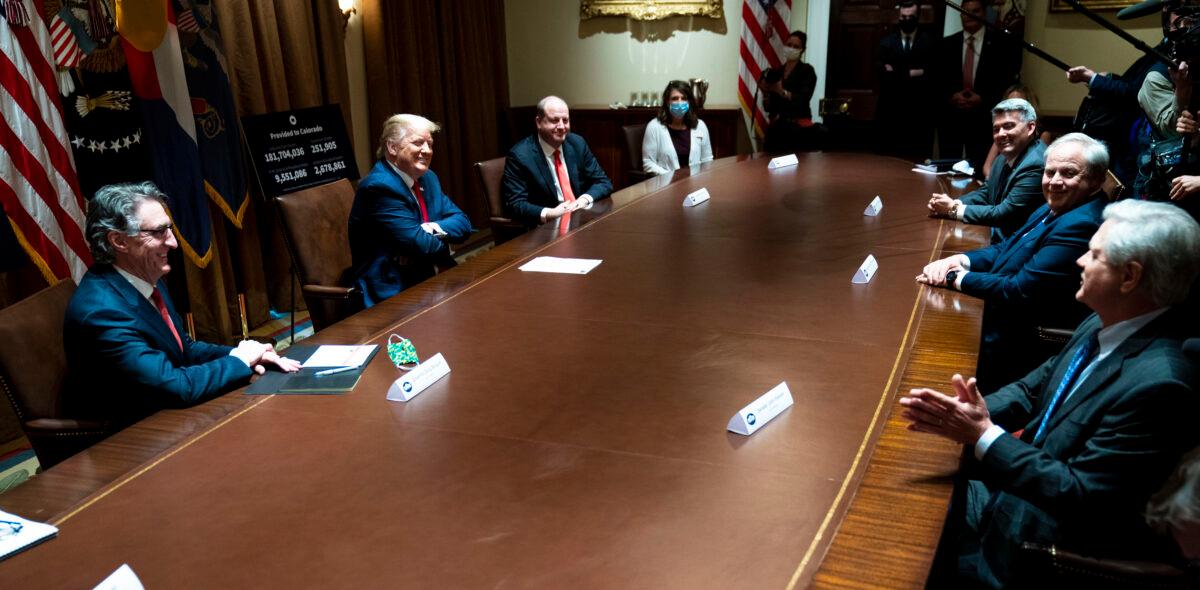 North Dakota Gov. Doug Burgum (L), President Donald Trump (2nd L), and Colorado Gov. Jared Polis (3rd L) during a meeting in the Cabinet Room of the White House on May 13, 2020. (Doug Mills/Pool/Getty Images)