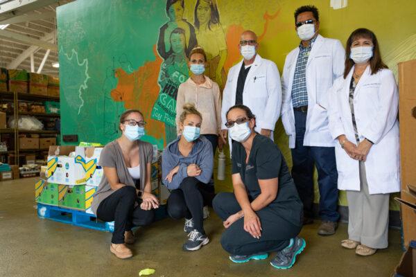 Share Our Selves staff pose at the organization’s headquarters in Costa Mesa, Calif., on Aug. 17, 2020. (John Fredricks/The Epoch Times)