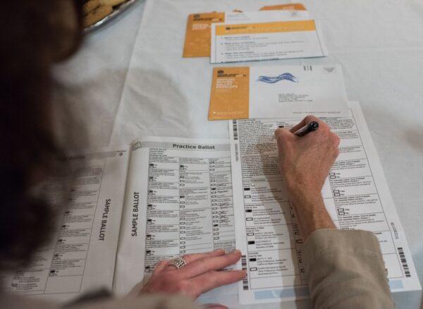 Voter Becky Visconti completes her mail-in ballot in Laguna Niguel, Orange County, Calif., on Oct. 24, 2018. (Robyn Beck/AFP via Getty Images)