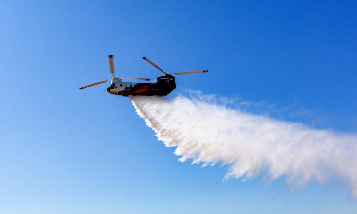 A Type 1 helicopter drops water in this 2020 file photo. (John Fredricks/The Epoch Times)