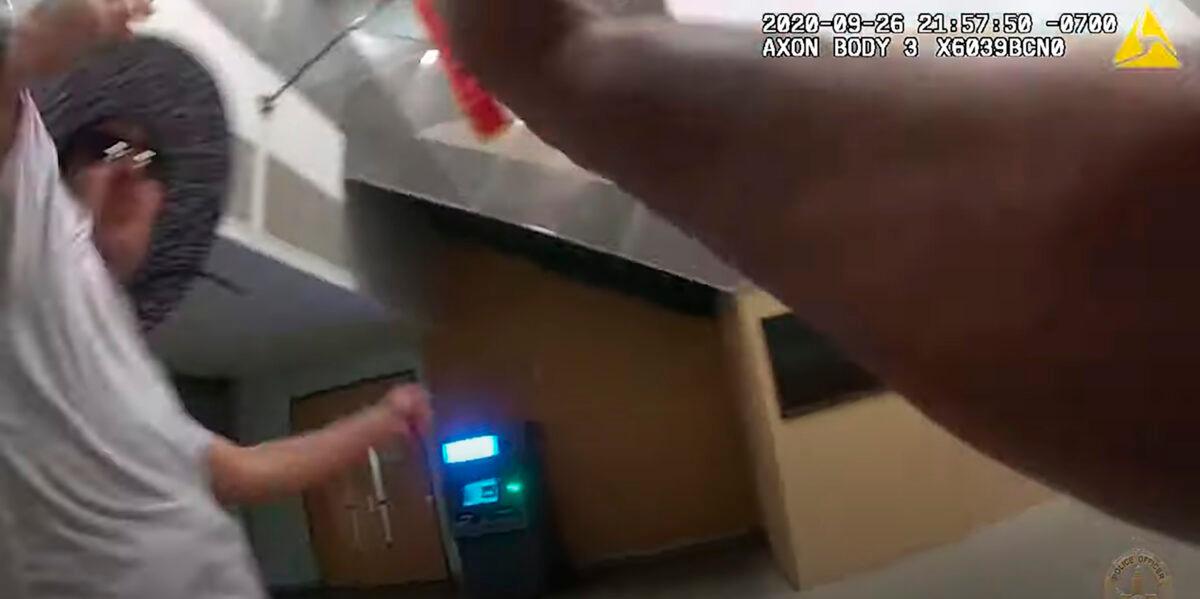 This photo from Los Angeles Police Officer Anthony Freeman's body-worn video shows the beginning of the attack by Jose Cerpa Guzman at the LAPD's Harbor Area station, on Sept. 26, 2020. (Los Angeles Police Department via AP)