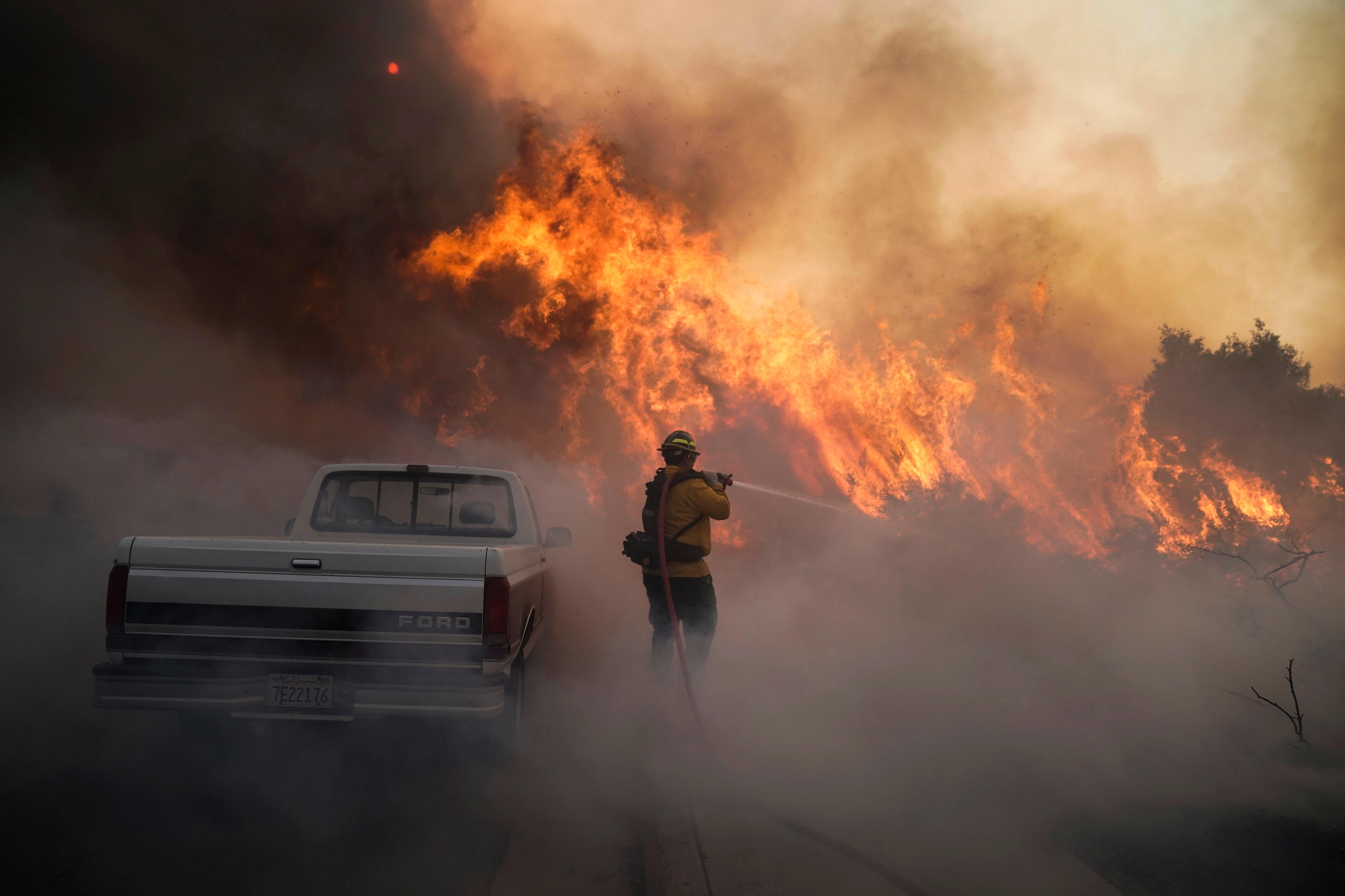 Firefighter Raymond Vasquez battles the Silverado Fire Monday, Oct. 26, 2020, in Irvine, Calif.(Jae C. Hong/AP Photo)