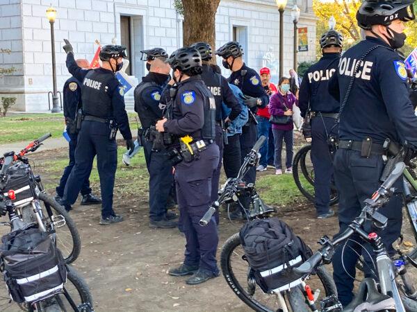 Police handle an incident at the rally at California’s State Capitol in Sacramento on Nov. 14, 2020. At least two counter-protesters were arrested at the rally. (Steve Ispas/The Epoch Times)