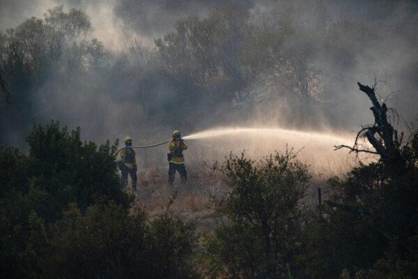 Firefighters fight the Bond Fire in Silverado Canyon, Calif., on Dec. 3, 2020. (John Fredricks/The Epoch Times)