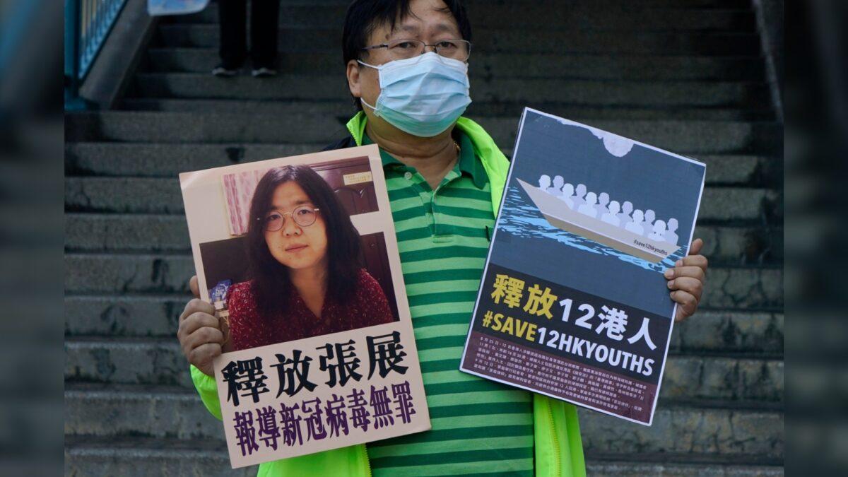 A pro-democracy activist holds a placard urging Chinese authorities to release Chinese citizen journalist Zhang Zhan and 12 detained Hongkongers outside the Chinese central government's liaison office, in Hong Kong, on Dec. 28, 2020. (Kin Cheung/AP Photo)