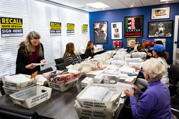 Volunteers sort recall mail, hoping to oust California Gov. Gavin Newsom, at Capital Campaigns Inc. in Newport Beach, Calif., on Jan 4, 2021. (John Fredricks/The Epoch Times)