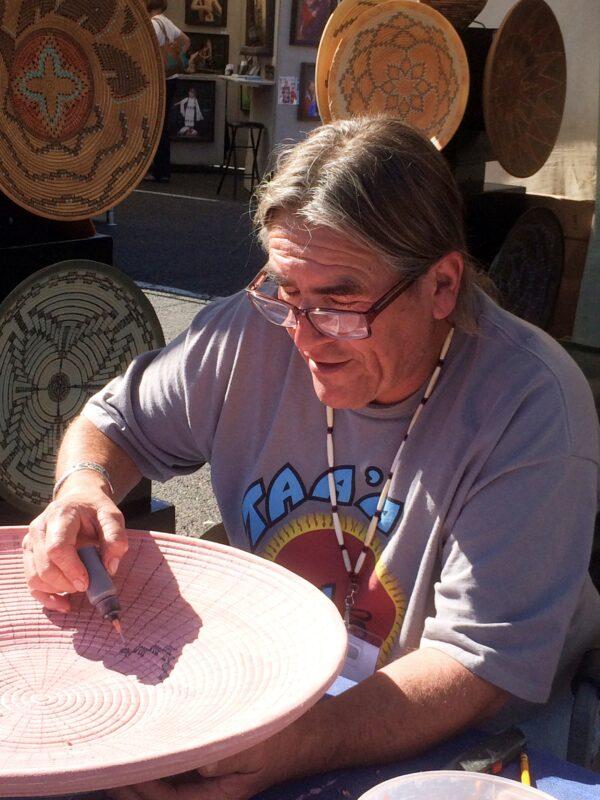 Rich Lopez paints a piece of his pottery. (Courtesy of Rich Lopez)